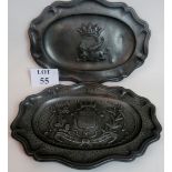 Two pewter trays decorated with heraldic crests,