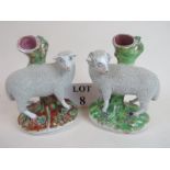 A pair of Staffordshire pottery spill holders modelled as sheep standing on a naturalistic bases