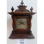 An oak cased bracket clock with silvered dial and twin-train movement, key & pendulum present,