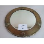 An Arts & Crafts copper frame bevelled circular wall mirror, c.