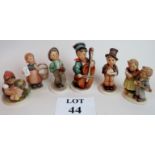 A collection of figurines of children, some Hummel marked Germany,