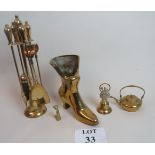 A collection of brass items to include a fireside set, a brass boot, a bell,