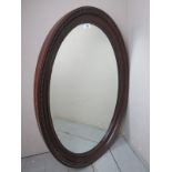 A 19th Century oval carved mahogany wall