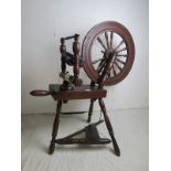 A 19th Century spinning wheel in good co
