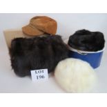 A brown mink fur hat, a white fur hat, a