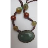 A quartz and garnet necklace est: £30-£5