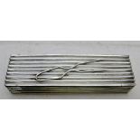 A silver pin box with hair pin decoratio