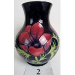 A contemporary Moorcroft vase, the bulbous form tube-lined with flowers and foliage on blue ground,