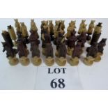 A hand carved chess set in the Berne Bears pattern, probably carved from a fruit-wood,