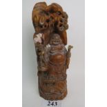 A Chinese carved hardwood group depicting a standing Buddha,