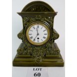 An antique ceramic mantle clock, in the Doulton style, porcelain dial,