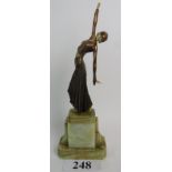 A reproduction Art Deco style simulated bronze and faux ivory figure of a dancing girl,