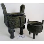 Two Chinese archaic-type bronze tripod censors, but of later construction,