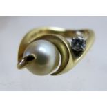 A diamond and pearl set ring, indistinct marks,