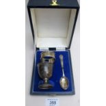 A three piece matched silver christening set, comprising of spoon, egg cup and napkin ring,