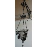 An Arts & Crafts wrought iron hanging lamp and bracket, ornate design,