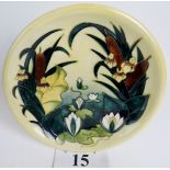 A Moorcroft cabinet plate, tube-lined with bull-rushes, lilies and foliage on a yellow ground,