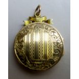 A 15ct gold locket with engraved decoration, total weight 5.