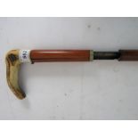 A 410 shooting walking stick with horn handle and a button trigger, slightly a/f, (U.