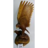 A large contemporary carved wooden sculpture depicting two eagles,