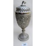 An Indian white metal heavy embossed trophy and lid,