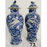 A pair of 19th century Chinese blue and white porcelain vases and covers, with painted reign marks,