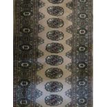 A 20th century small Persian runner on fawn ground,