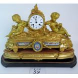 An impressive 19th century French ormolu clock with porcelain floral plaques,