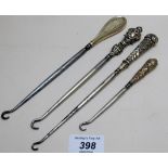 A collection of 4 silver handled button hooks,