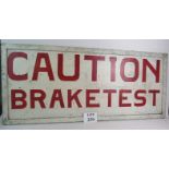 A vintage painted wooden sign 'Caution Brake Test',