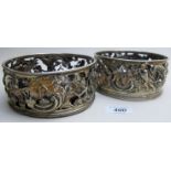 A pair of early Cork silver coasters decorated with cherubs and vines, one marked 'CT',