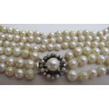 A three stone graduated pearl necklace with pearl and diamond clasp,
