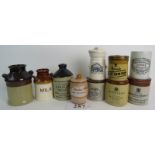 A collection of stoneware and ceramic advertising and storage containers,