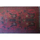 A small 20th century Persian runner on claret ground,