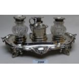 A fine Victorian silver inkstand, having two bottles and centre taper stick,