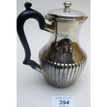 A small silver hot water jug with half fluting, London 1899,