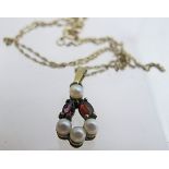 A 9ct gold pearl and garnet pendant on a fine chain est: £80-£120