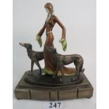 A reproduction Art Deco style simulated bronze sculpture, depicting elegant lady and two Borzoi,