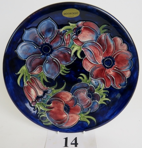 A Moorcroft cabinet plate, tube-lined with flowers and foliage on a blue ground,