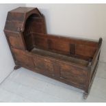 A Victorian oak child's rocking crib of