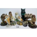 A collection of owl figurines, including