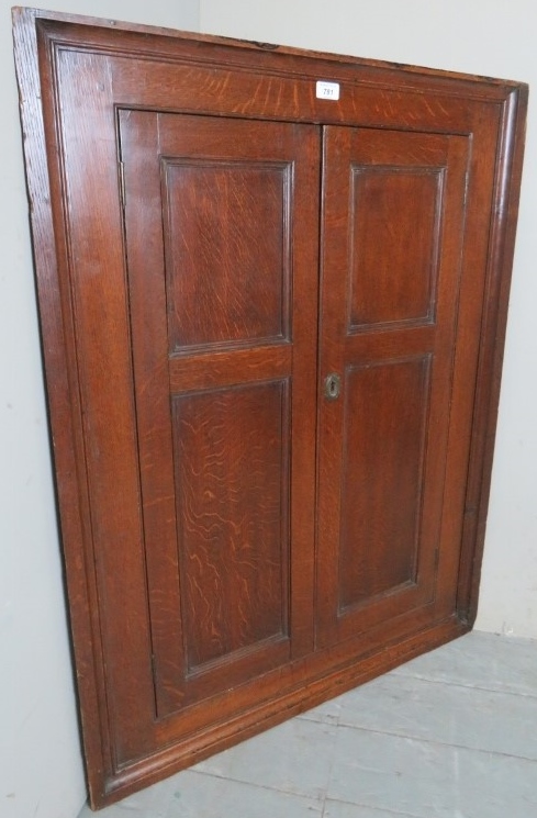 A Georgian oak corner cupboard with doub