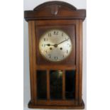 A c1920's oak cased striking wall clock, with inset bevelled glass panels, 64cm high (a/f).