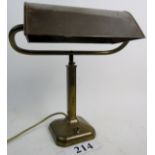 A vintage brass desk lamp, with adjustable metal shade,