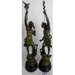 A pair of French patinated and bronzed sculptures, depicting classical figures in triumphant poses,