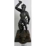 A 19th century patinated spelter statuette cast as a Knight, on Heraldic plinth base, 62cm high.