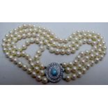A fine quality 3 strand pearl necklace with diamond and opal clasp, each row approx.