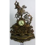 A highly decorative French bronzed and silvered cast metal mantel clock, inset with onyx panels,