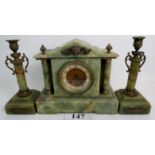 A 19th century French gilt-metal mounted green onyx three piece clock garniture of Romanesque