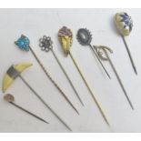 A collection of various stick pins to include a fox's head inset with turquoise. est: £80-£120.